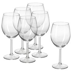 six wine glasses are lined up on a white background, with one empty glass in the middle