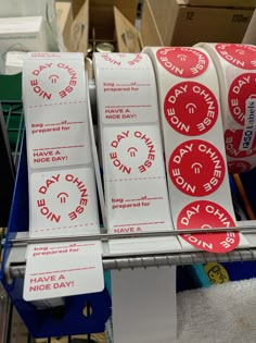 some red and white stickers are on a shelf next to other items in a store