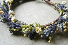 a close up of a wreath made out of twigs and flowers on a cloth surface