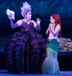 two women dressed as mermaids on stage