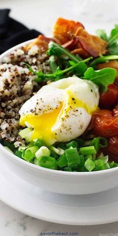 This quinoa bowl has it all. Roasted grape tomatoes, crispy bacon, fresh arugula, and a creamy Dijon sauce for a filling breakfast.