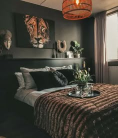 a bed room with a neatly made bed and a painting on the wall above it