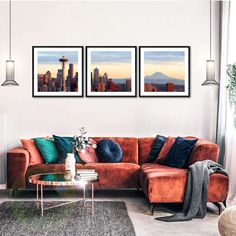 a living room with two pictures hanging on the wall