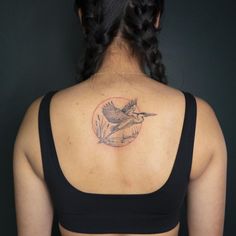 a woman with a bird tattoo on her back