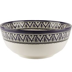 a blue and white bowl with designs on it's sides, sitting in front of a white background