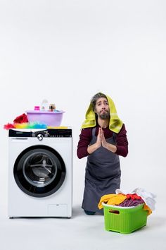 a man sitting in front of a washing machine