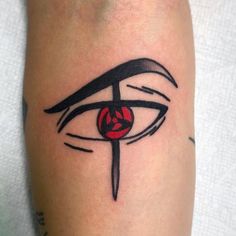 a close up of a person's arm with an eye and a knife on it