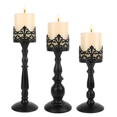 three black candles are sitting next to each other