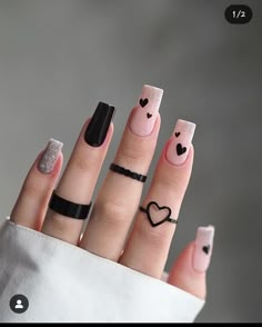 a woman's hand with four different nail designs on it and two hearts drawn on the fingers