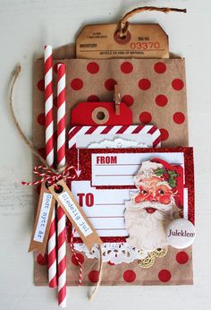 a christmas card with red and white polka dots on it, next to two paper straws