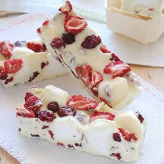 two pieces of cake with strawberries and ice cream