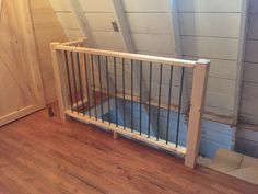 a wooden floor with a metal gate on it and a door in the back ground