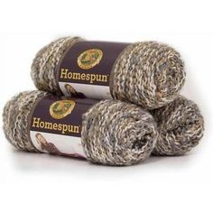 three skeins of yarn with the words homespun written on them in brown and white