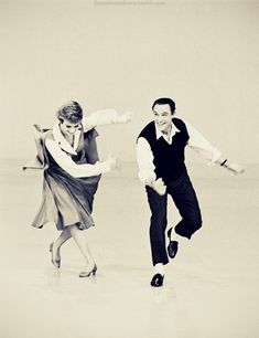 a man and woman are dancing on the dancefloor in an old fashion photo