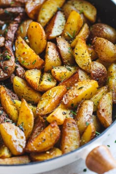 cooked potatoes with herbs and seasoning in a pan