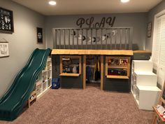 a play room with a slide and bookshelf