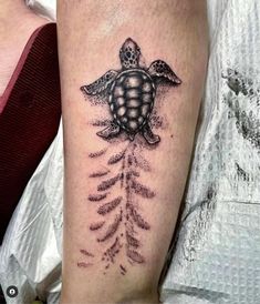 a turtle with an arrow tattoo on its arm