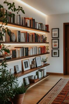 the bookshelves are full of books and plants