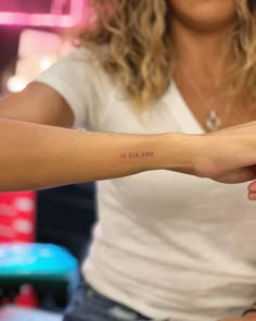 a woman with a small tattoo on her arm