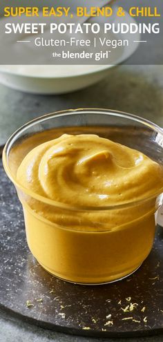 a bowl filled with yellow sauce on top of a table