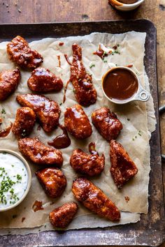 chicken wings and dipping sauces on parchment paper