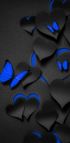 blue butterflies and black hearts on a dark background