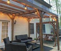 an outdoor living area with patio furniture and string lights on the pergolated roof