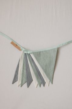 a green and white bunting is hanging on the wall