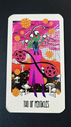 a playing card with an image of a woman in pink and purple on the front