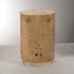 a round wooden table with holes in the middle and wood grain on it's sides