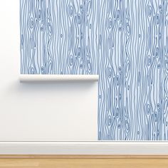 an empty room with blue wood grain wallpaper