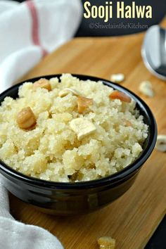 a bowl filled with rice sitting on top of a wooden cutting board