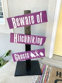 a wooden sign that says beware of hitchhiking ghosts