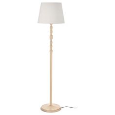 a wooden floor lamp with a white shade on the base and a cord attached to it