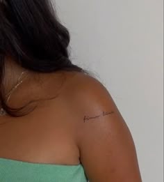 a woman with a small tattoo on her shoulder