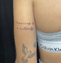 a woman with a tattoo on her arm that says happiness is a butterfly and an eagle