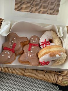 three decorated cookies in a box on a table