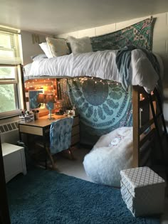 a bedroom with a bunk bed, desk and chair next to a blue rug on the floor