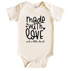 a baby bodysuit with the words made with love and a little diamond