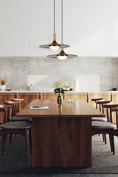 a dining room table with chairs and lights hanging from the ceiling in front of it