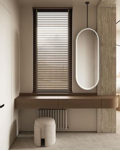 a bathroom with a large mirror on the wall and a stool in front of it