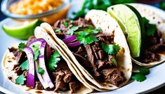 three tacos with meat, onions and cilantro are on a white plate