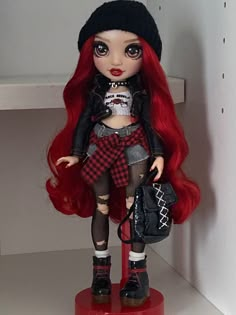 a doll with red hair is standing on a shelf