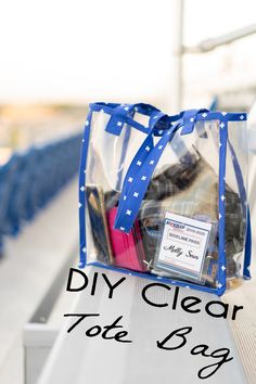 a clear tote bag sitting on top of a wooden bench with the words diy clear tote bag