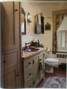 a bathroom with a sink, toilet and window