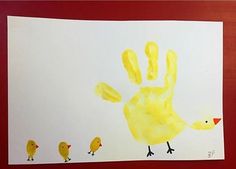 a child's handprint with five little chicks on it