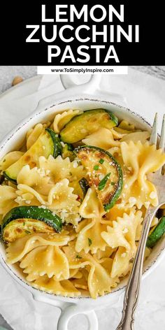 lemon zucchini pasta in a white bowl with a fork and spoon on the side