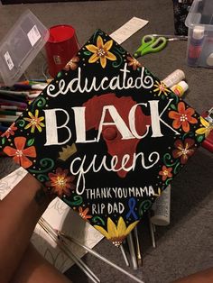 a decorated graduation cap with the words, education black queen thank you mama