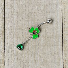 Product DetailsGreen Gem Shamrock Ladybug St Patricks Dangle Belly Ring Luck can be a ladybug when you're rocking this 14 gauge navel ring! It's made with a 3/8" durable 316L surgical grade stainless steel curved barbell with a 5mm top ball end. The bottom end features a shamrock charm with three green leaves. Sitting on the shamrock is a ladybug, with red inlaid wings and simple embellishment and there's a green gem drop dangling from the shamrock's base. You'll never want to leaf this Saint Pa Cherry Belly Ring, Ladybug Ring, Green Navel Piercing, Mushroom Belly Button Ring, Ladybug Nose Stud, Ladybug Belly Button Ring, Belly Piercing Ring, Jewelry Promotion, Dangle Belly Rings