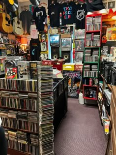 a room filled with lots of different types of records and cds on shelves next to each other